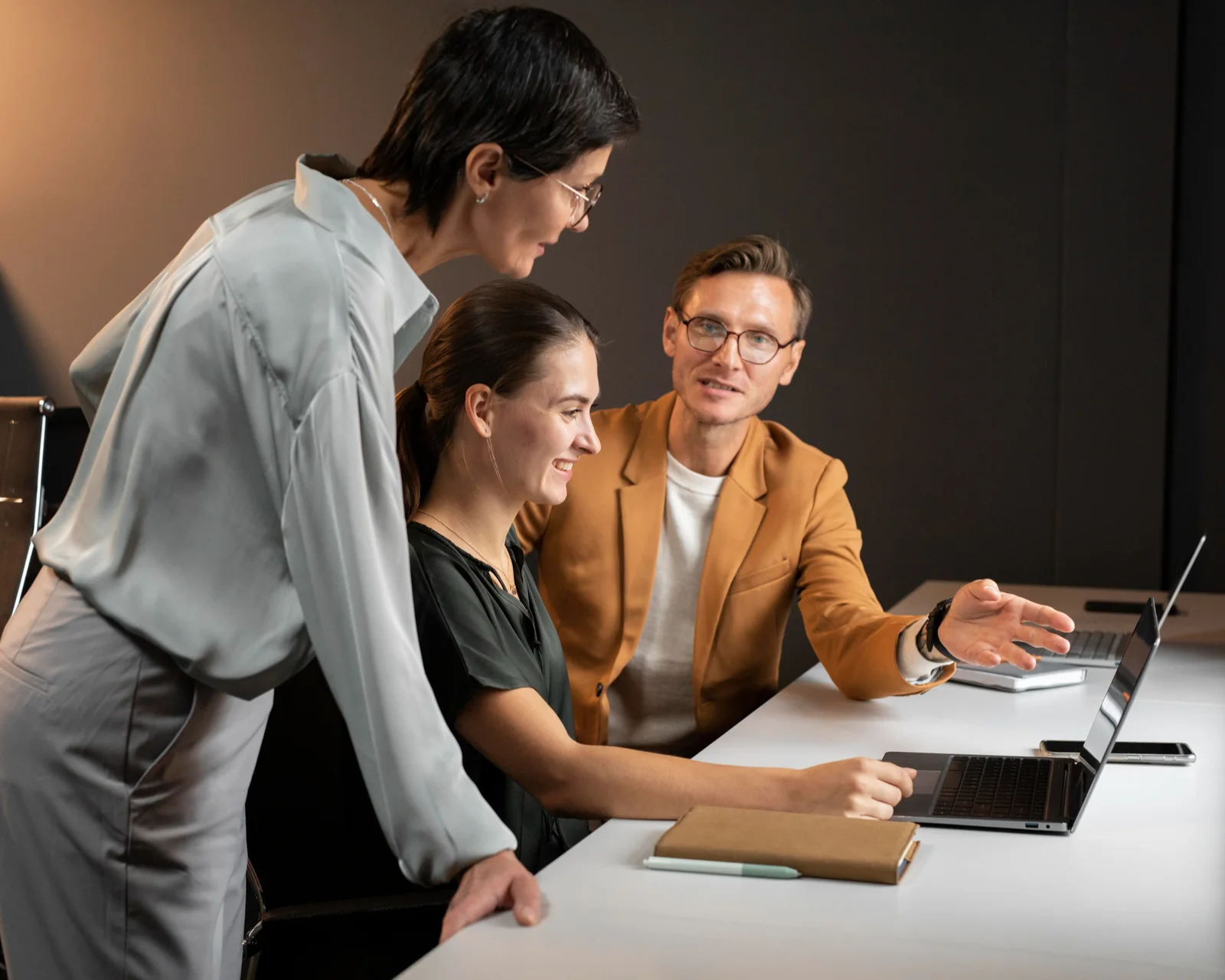 A partner and two advisers building the fact base at a client's table