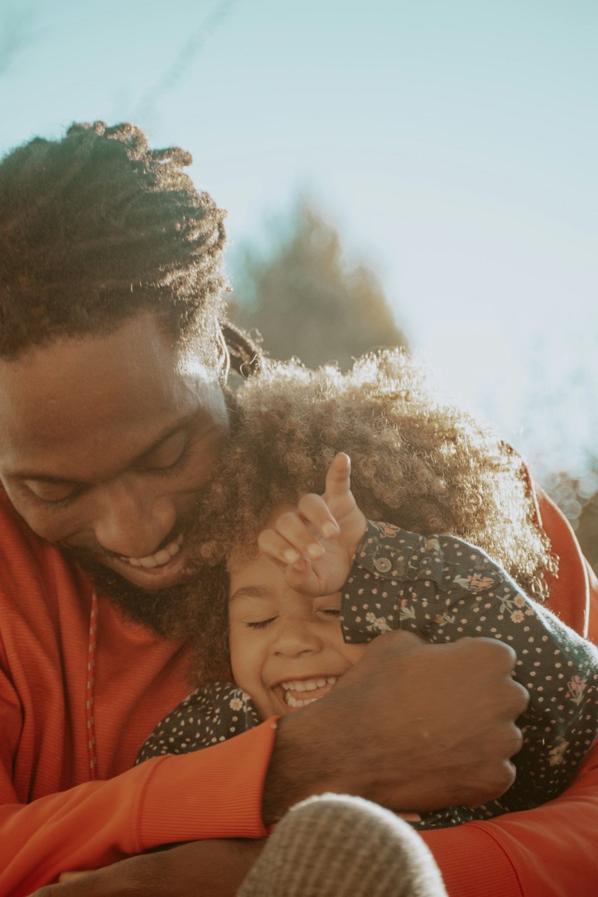 A father and daughter laughing together