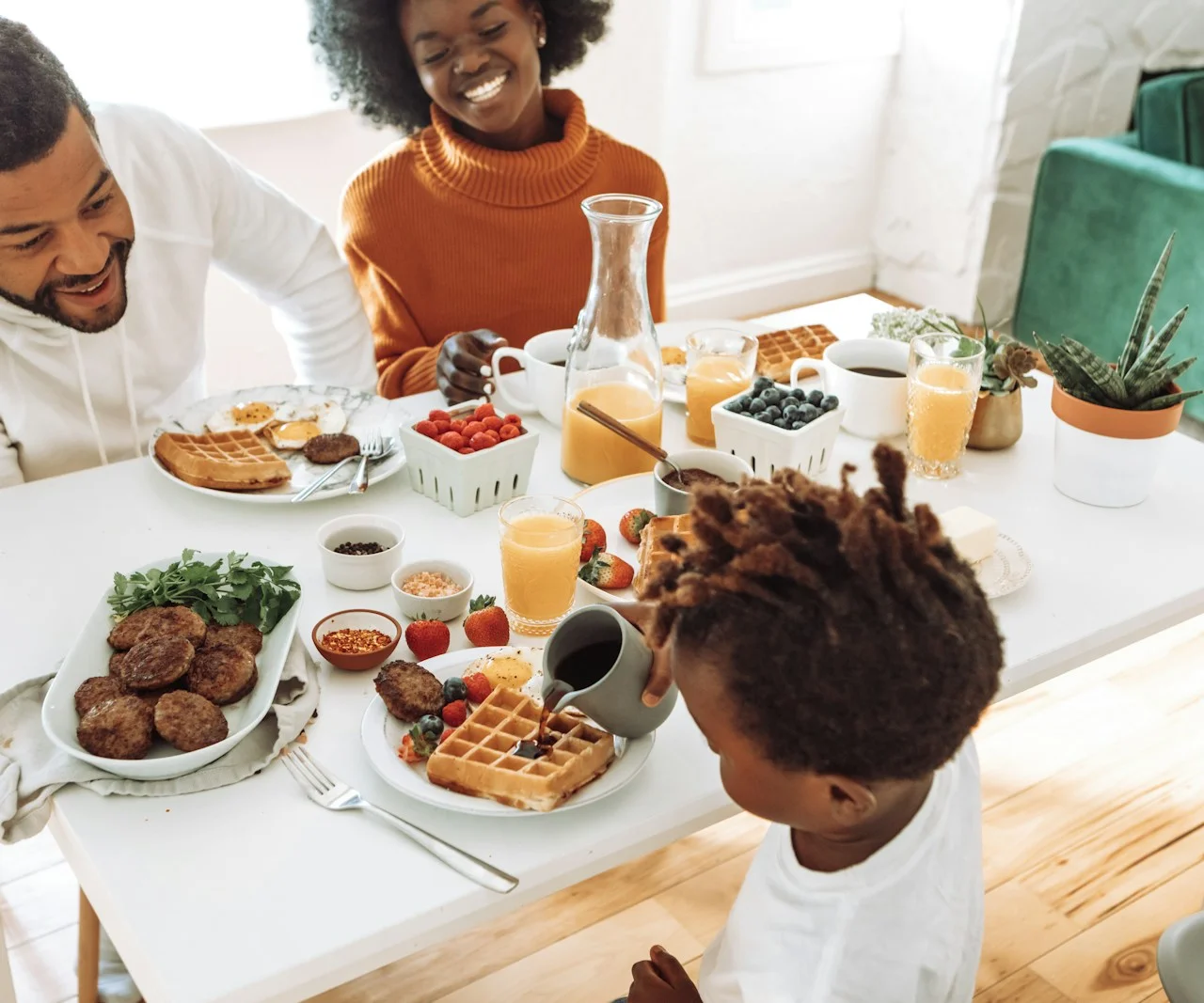 A family sharing breakfast together at a sunny kitchen table