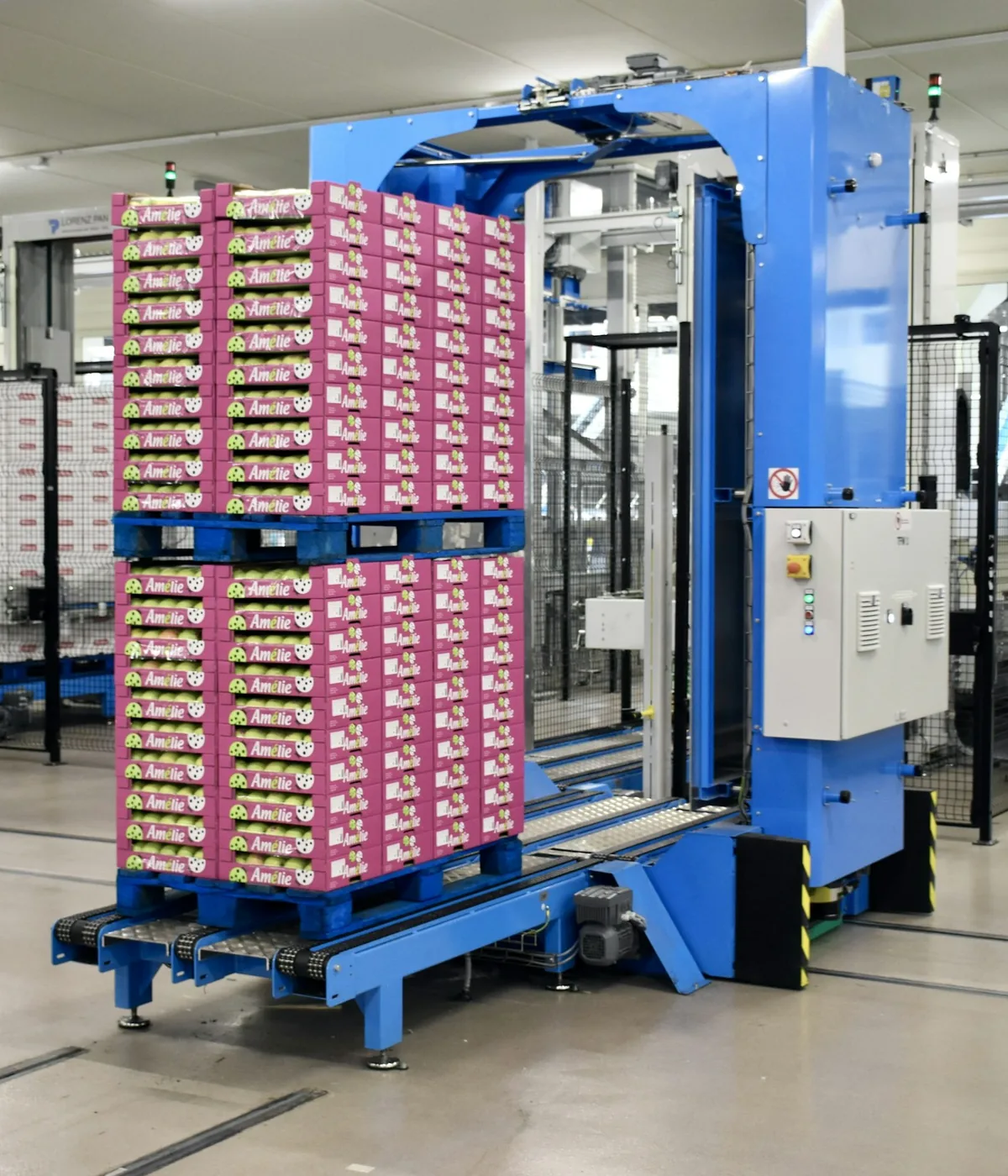 Finished pallet of pink cases wrapped at a blue palletising station