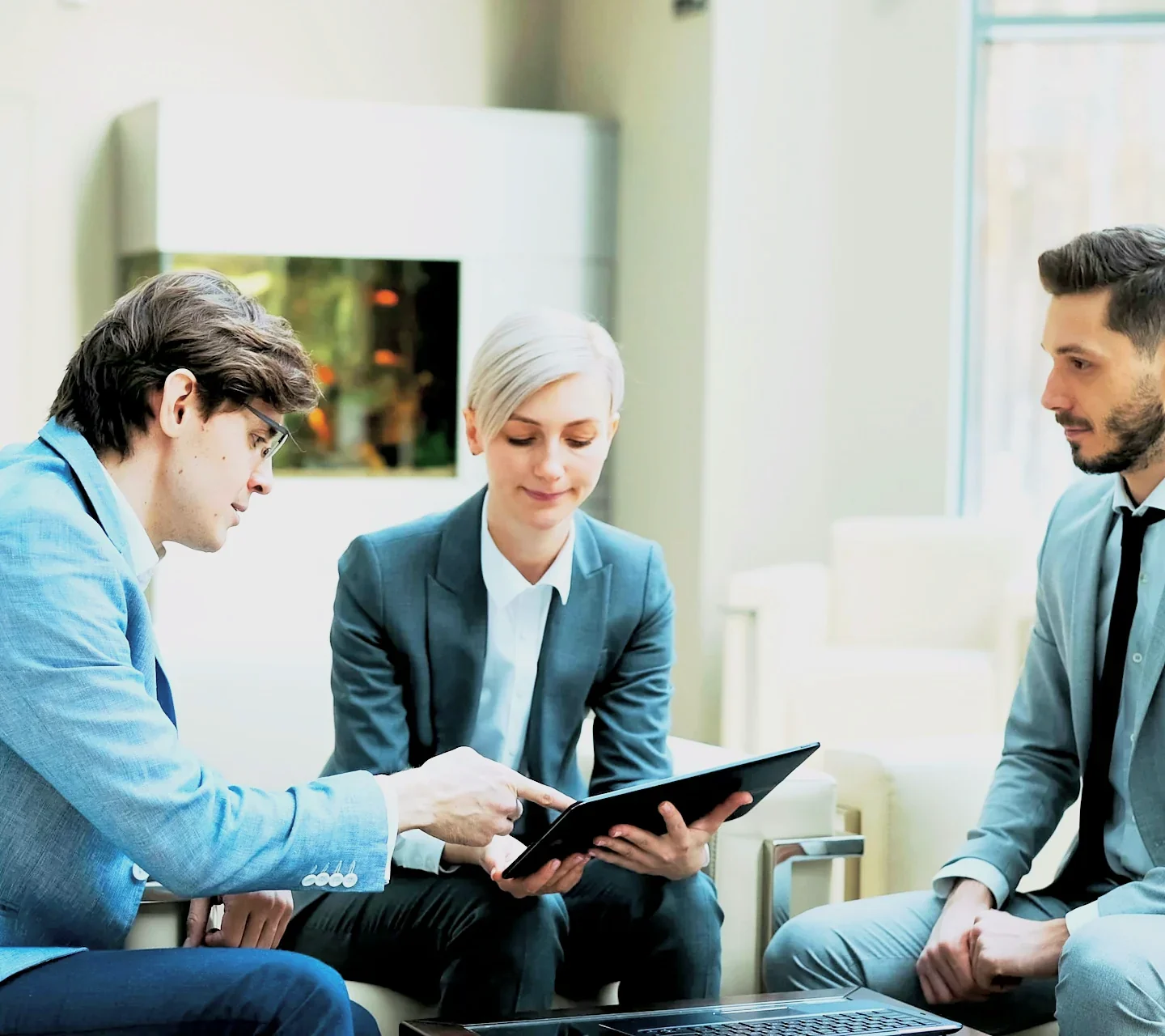 An Ashgrove advisor walking two clients through their plan on a tablet