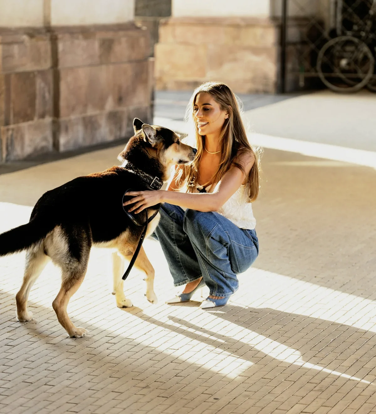 Ziggy, now healthy, greets his adopter Dana on a sunny street