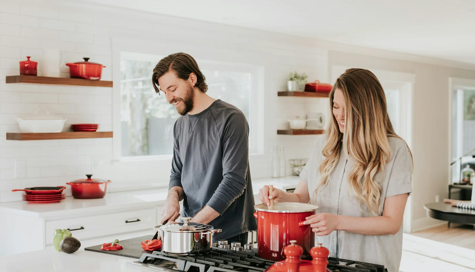 A homeowner cooking at the window of her newly finished kitchen