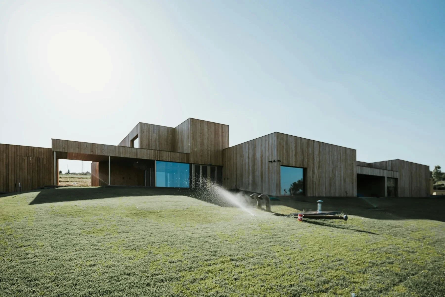 Long low timber school on a green lawn