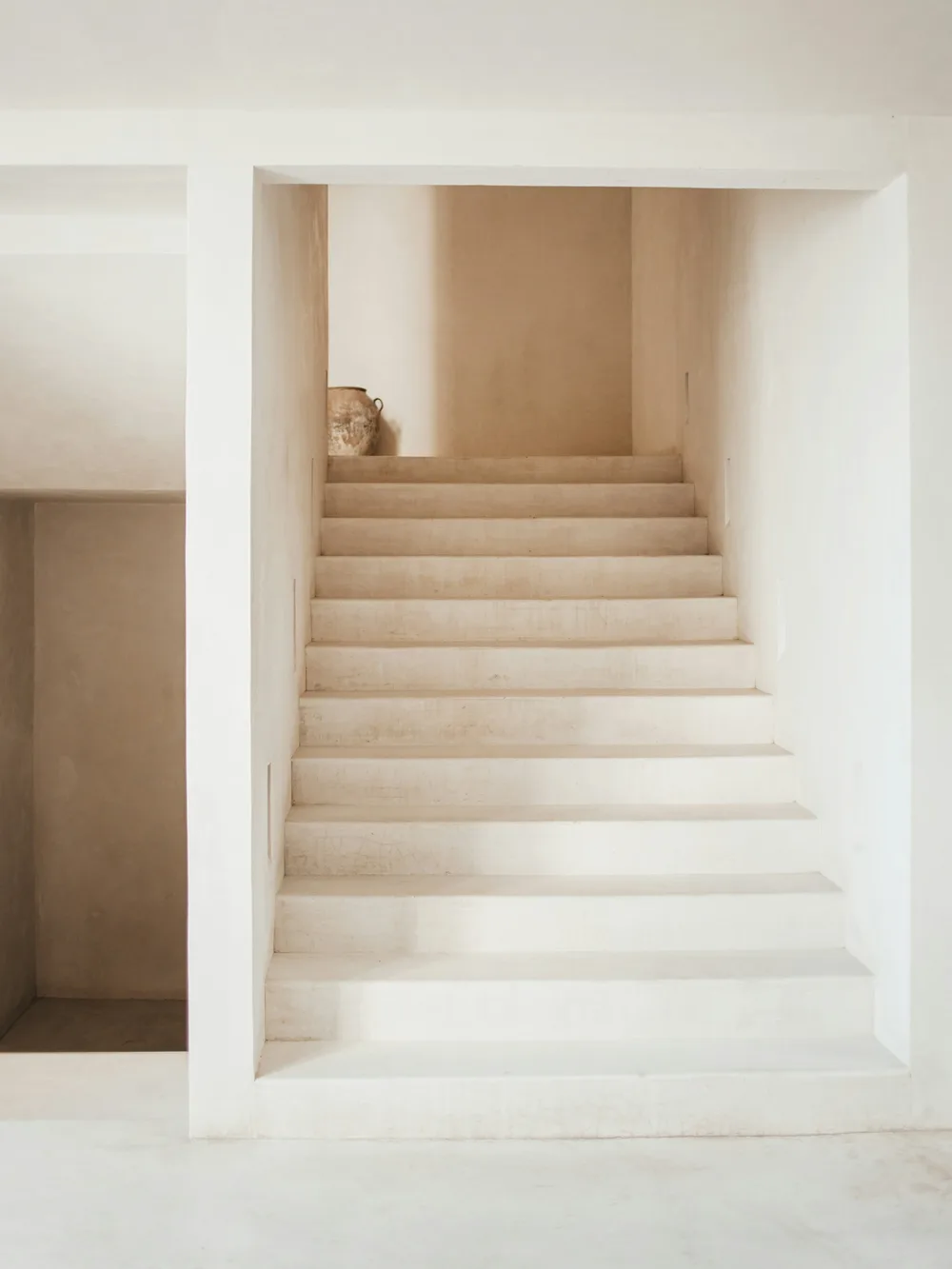 Stair and walls in pale lime plaster