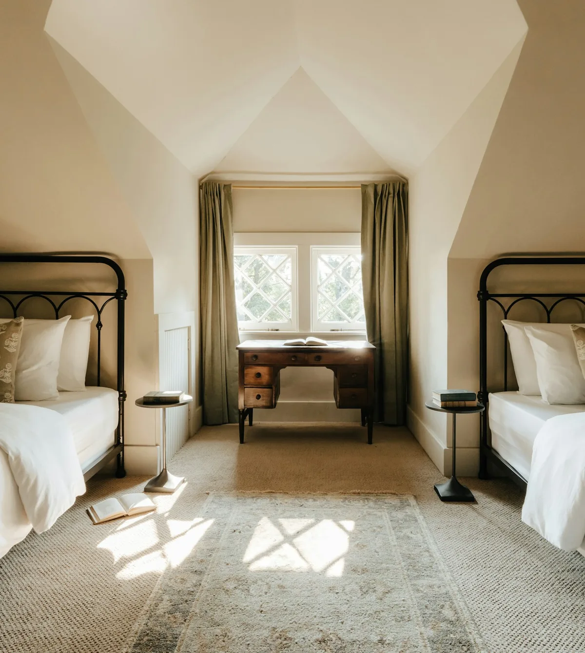 Hotel Havgaard twin room under a sloped ceiling, sun on the rug