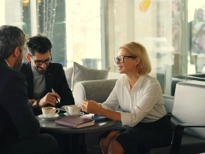 Ruth talking a client through the fee over coffee