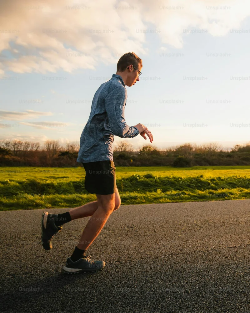 A runner checking his watch on a road after a run